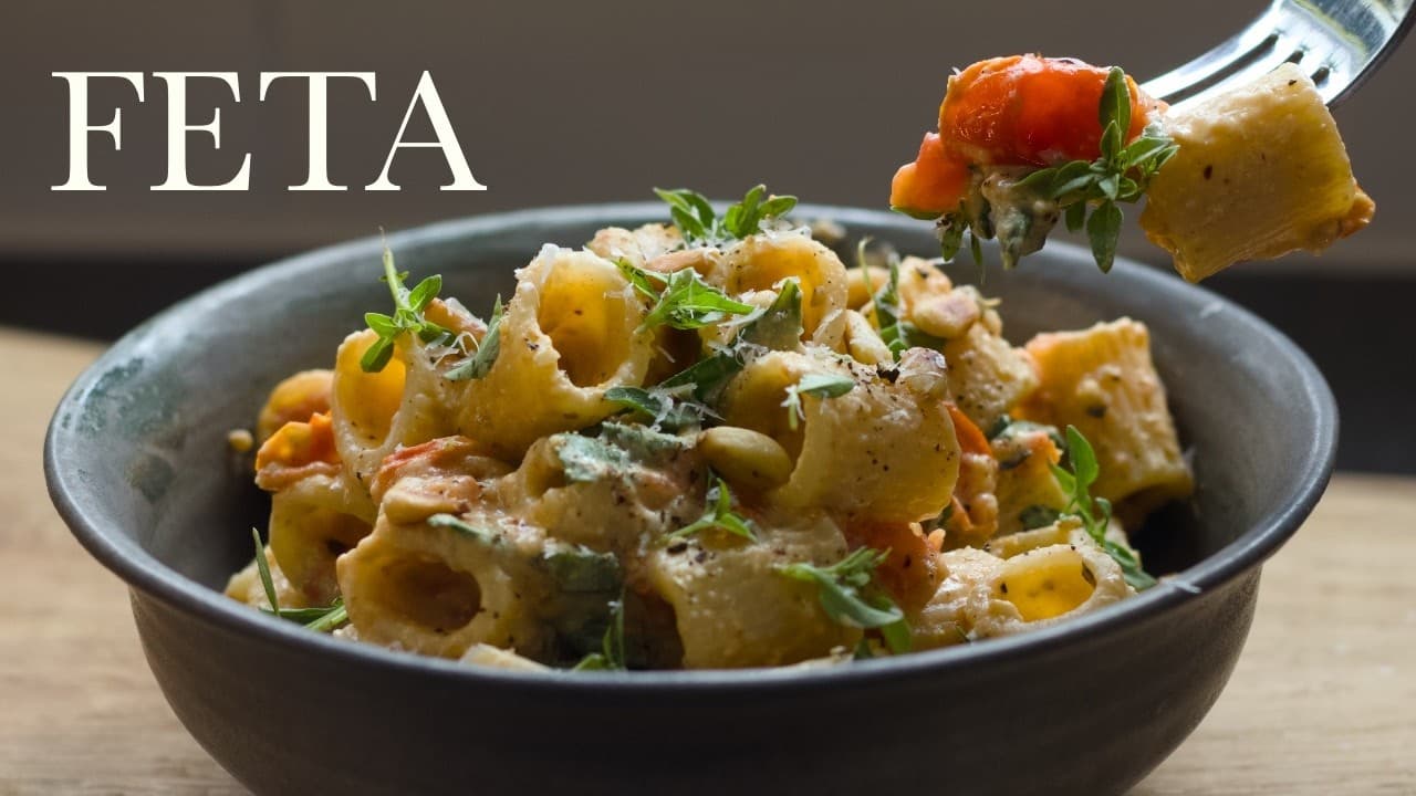 Baked feta pasta, a still from its video, with the channel name and the recipe title in text across it