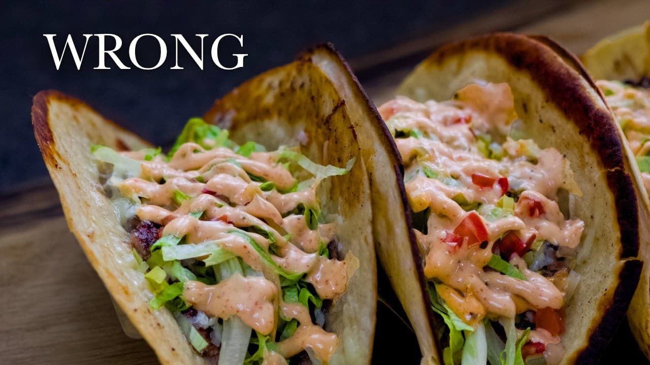 Crispy beef smash tacos, a still from its video, with the channel name and the recipe title in text across it