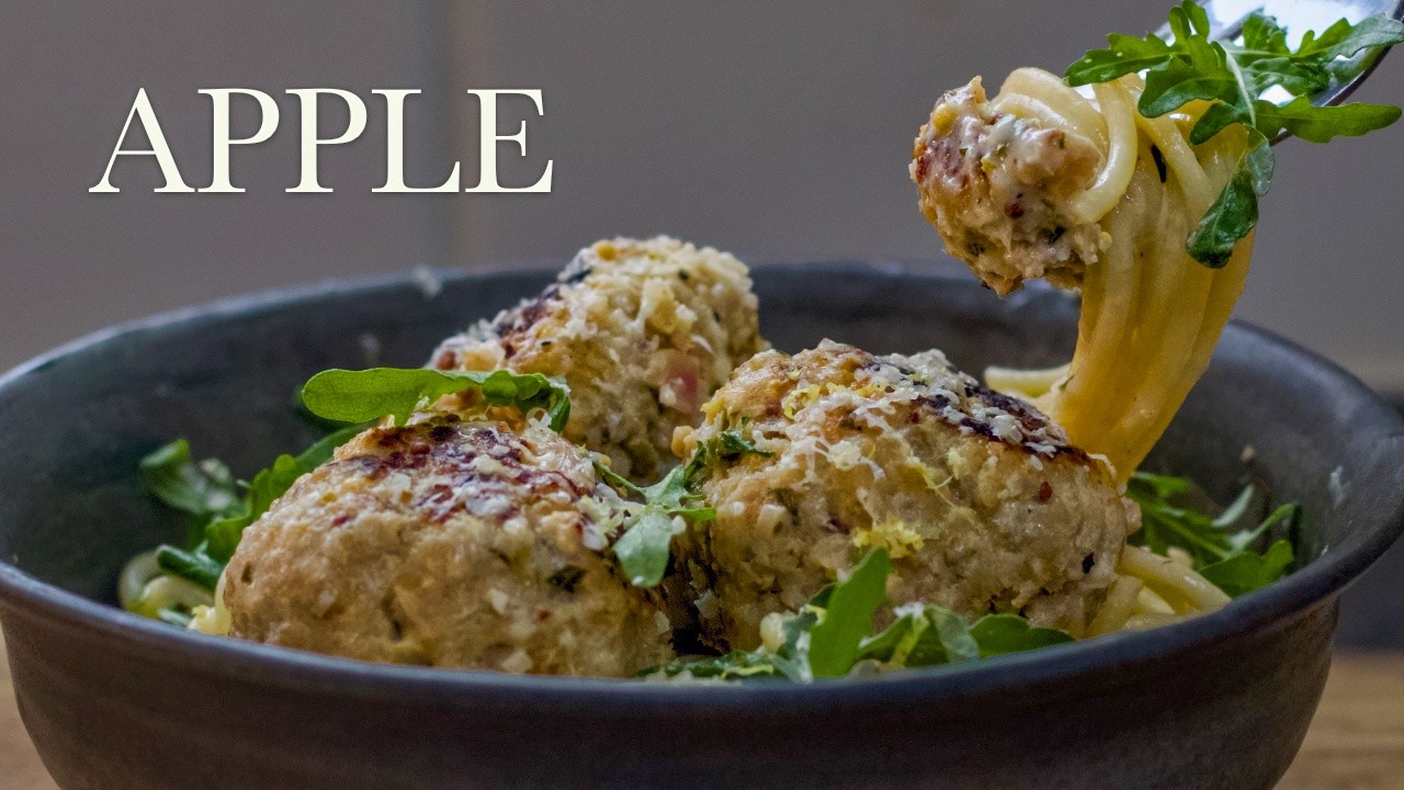 Pork and apple meatballs in creamy cider sauce, a still from its video, with the channel name and the recipe title in text across it